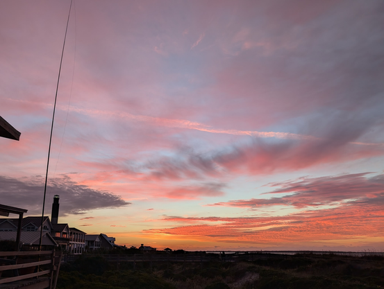 Sunrise with a ham radio wire antenna dangling from a fiberglass push-up mast at one side. The picture doesn't do the sunrise justice.