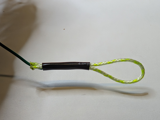 Shrunk tubing after heat applied, holding wire and loop together