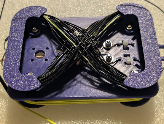 Linked dipole form showing one leg of a dipole with many links in it wound up for storage. The wire is wound in a figure eight to avoid twists. Several of the links are partially visible in it.