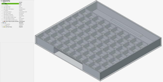 FreeCAD screenshot of typecase with lid. The lid is transparent, showing the typecase underneath. At the front is a space for pulling the lid off. At the back is a larger recess for holding tools.